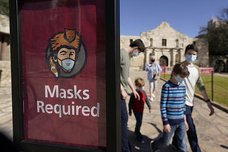 The Latest: Study finds masks, dining rules help curb spread
