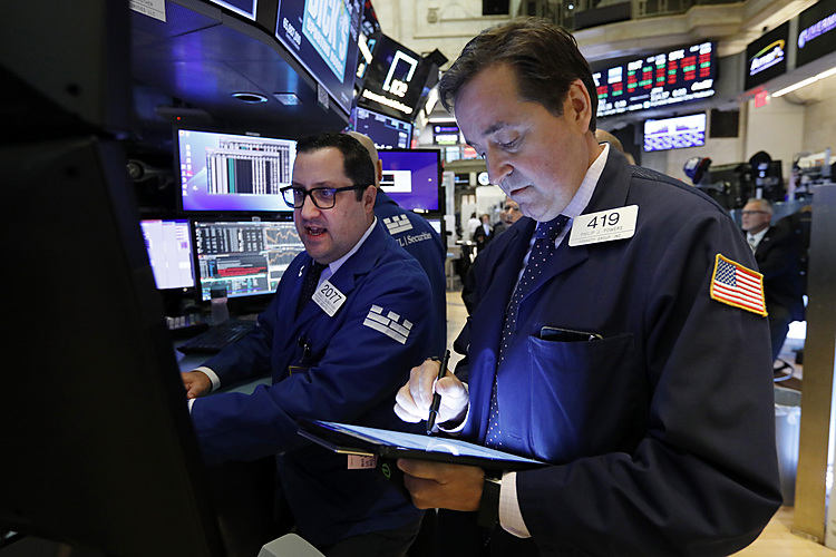 After some wobbling, stocks close higher on solid earnings