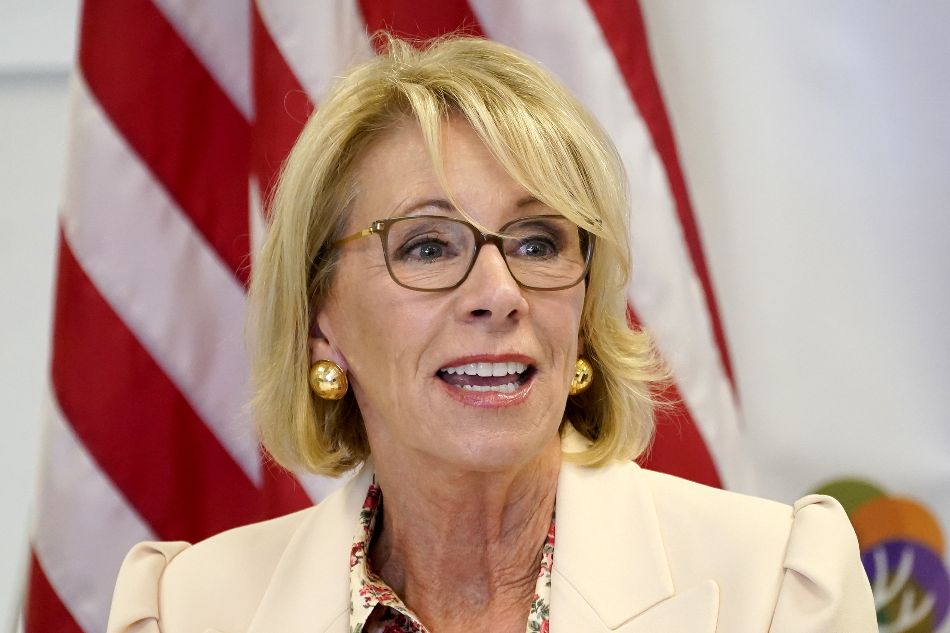 The Latest: Education head DeVos quits, cites Trump rhetoric